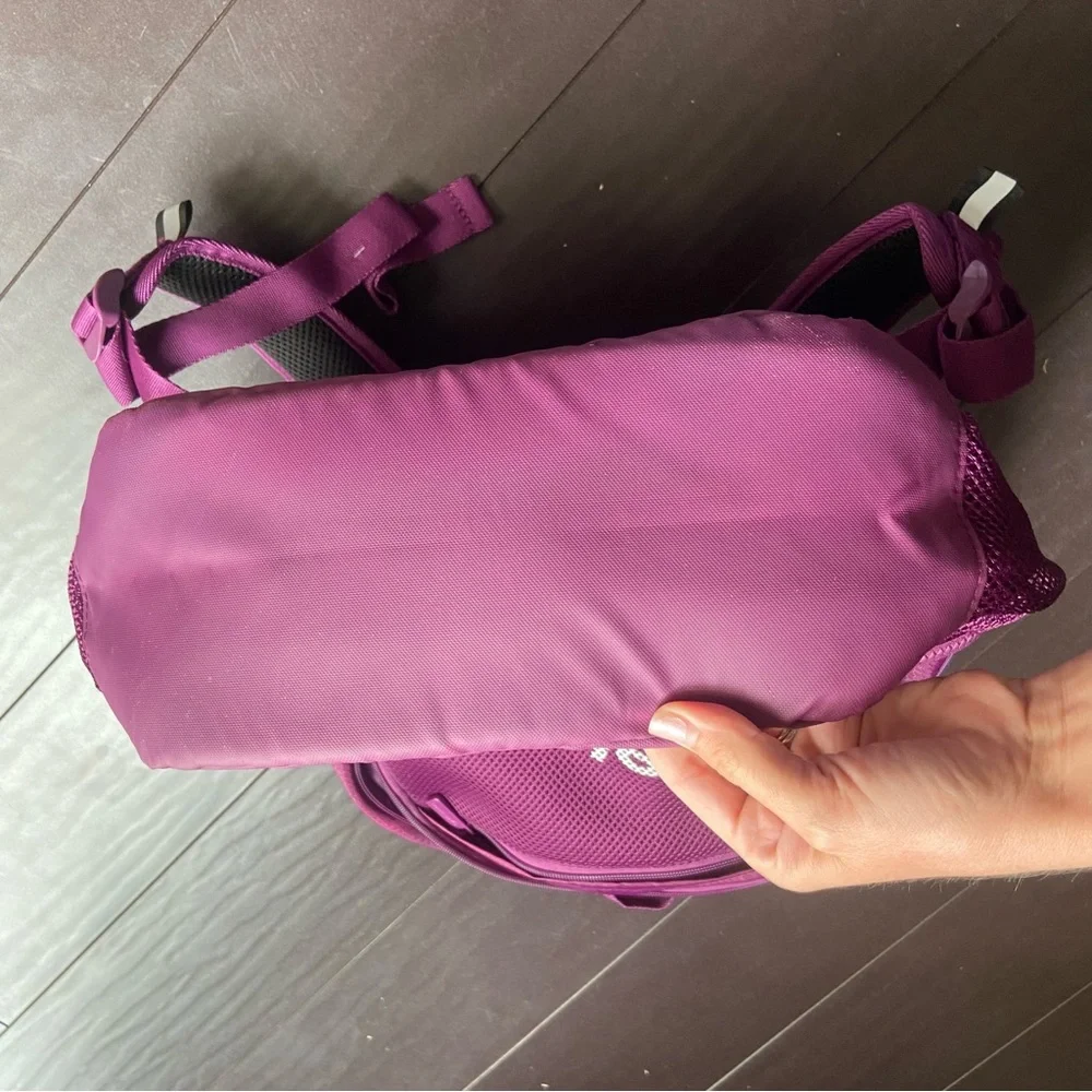 Purple Reebok book bag with tear right near strap